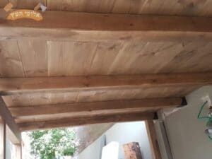 פרגולת עץ מחופה מותקנת במרפסת קטנה בשכונת מורשה ברמת השרון